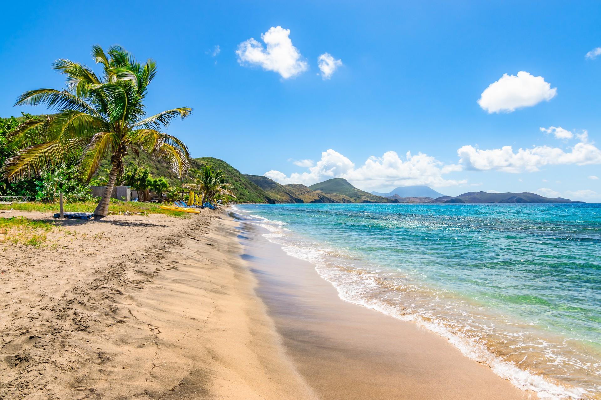 Enjoyable beach with turquise water in Nevis on a sunny day with some clouds