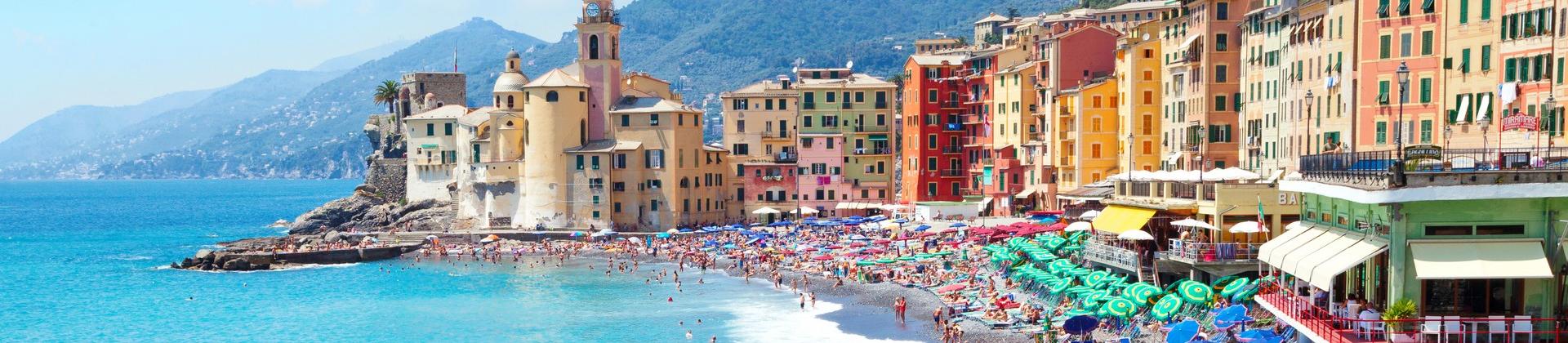 Aerial view of beach with a lot of people in Camogli on a sunny day with some clouds