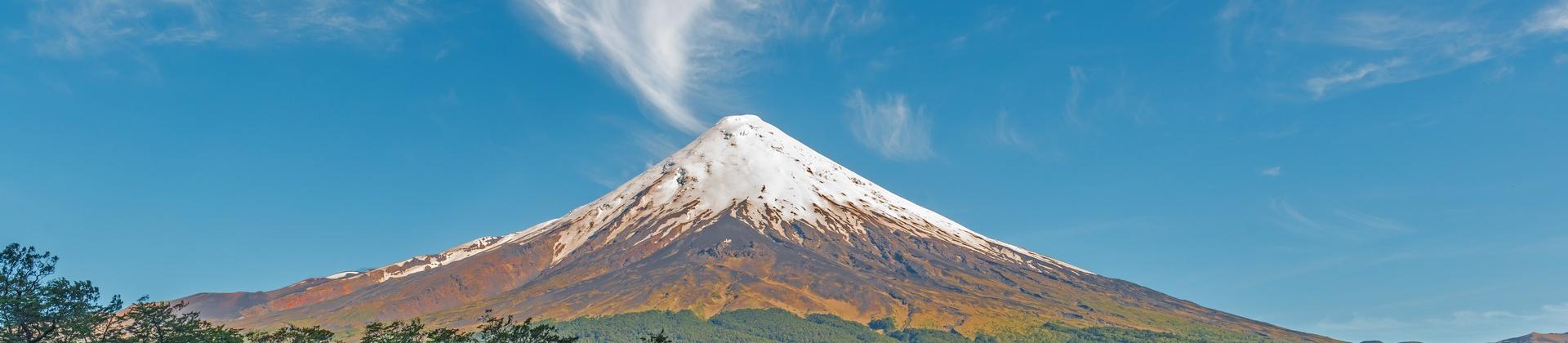 Mountain range near Pucón in sunny weather with few clouds