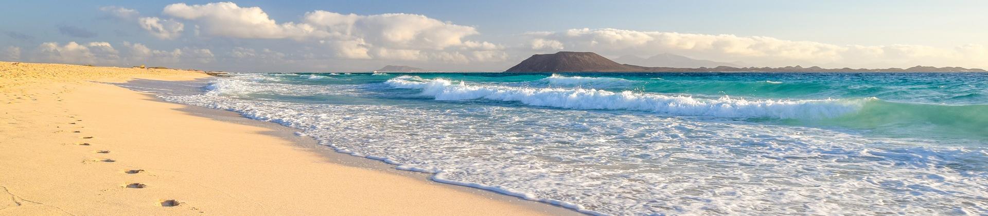 Enjoyable beach in Canary Islands on a sunny day with some clouds