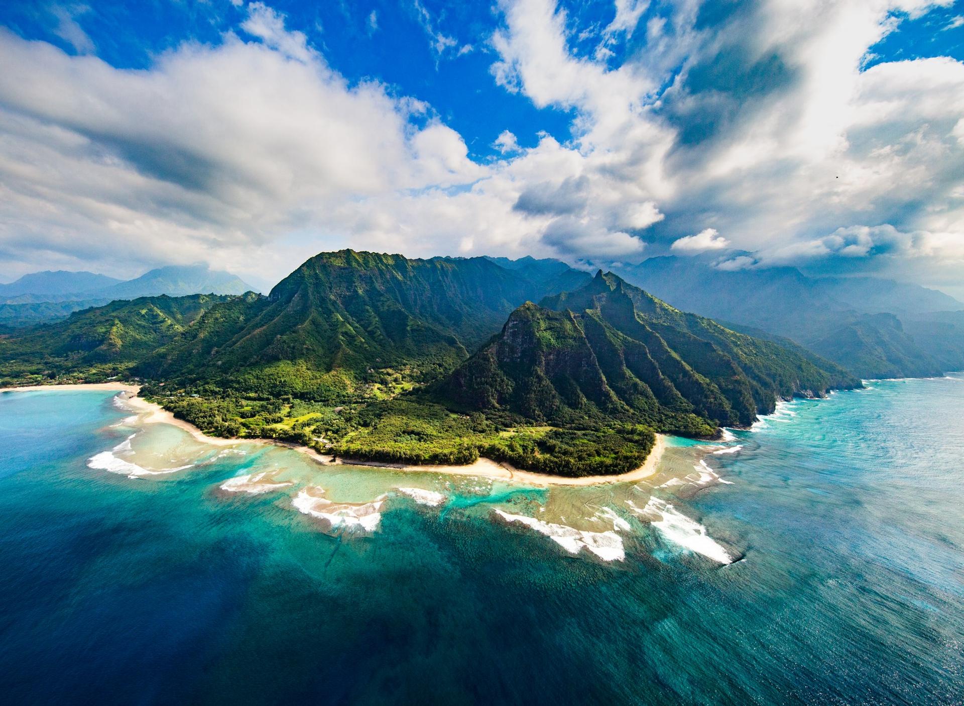 Aerial view of beach in Kauai in partly cloudy weather