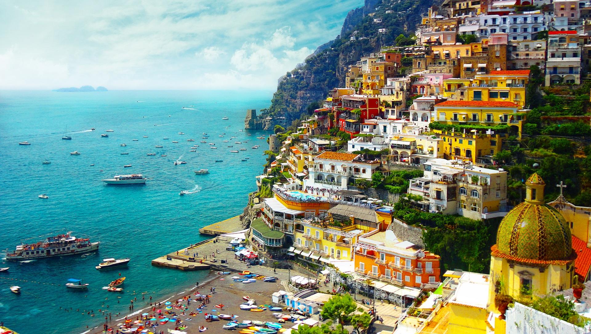 Aerial view of boat in Positano in sunny weather with few clouds