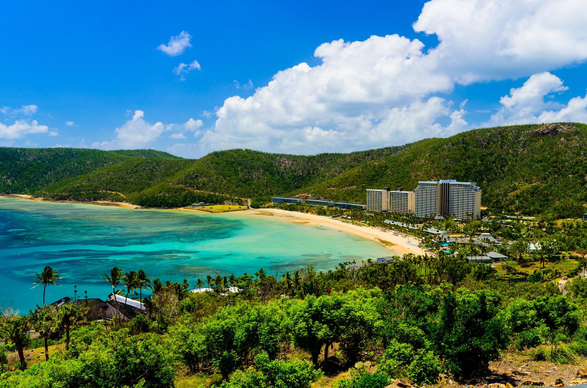 Beach with turquise water in Hamilton Island in sunny weather with few clouds