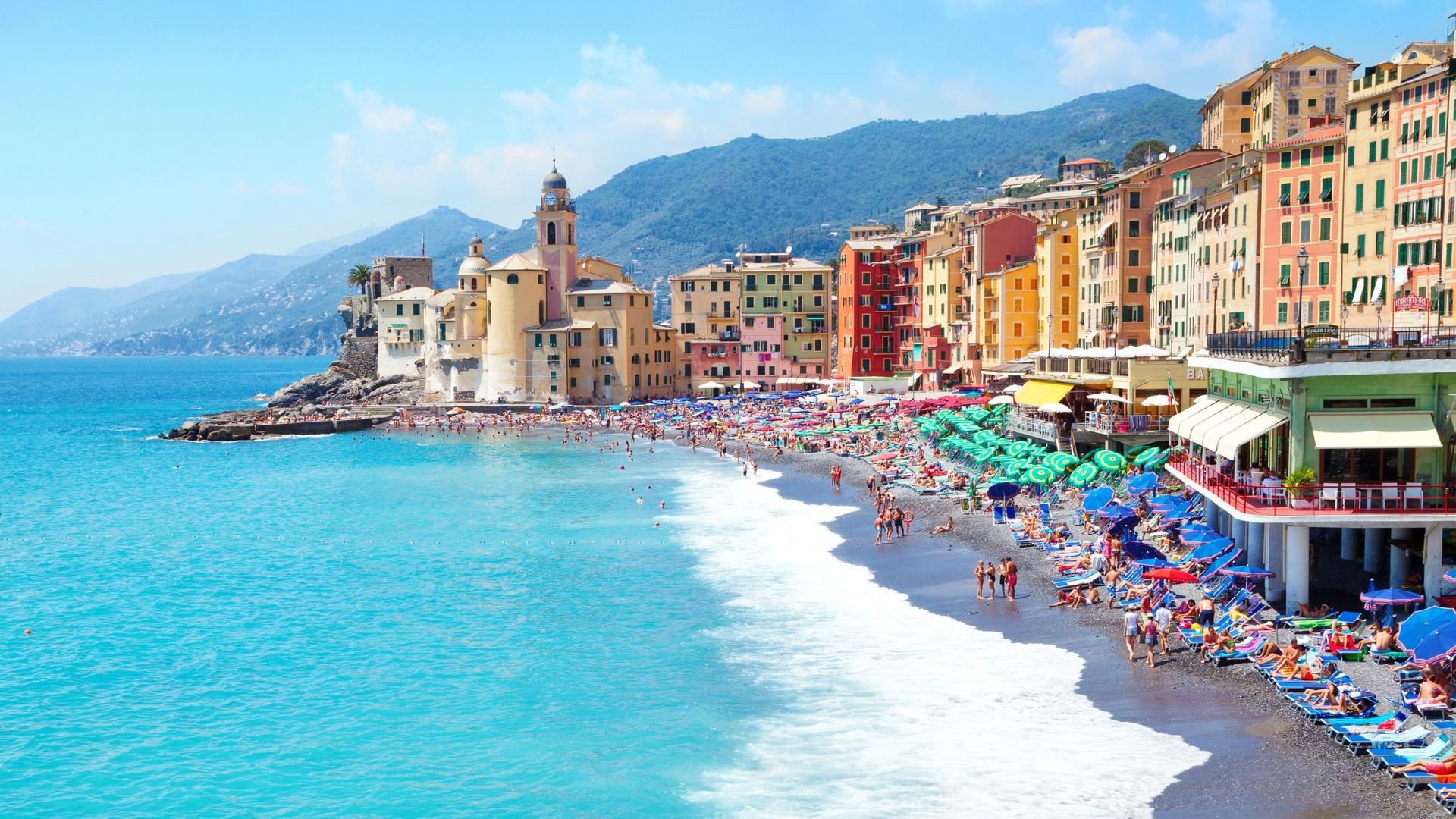 Aerial view of beach with a lot of people in Camogli on a sunny day with some clouds