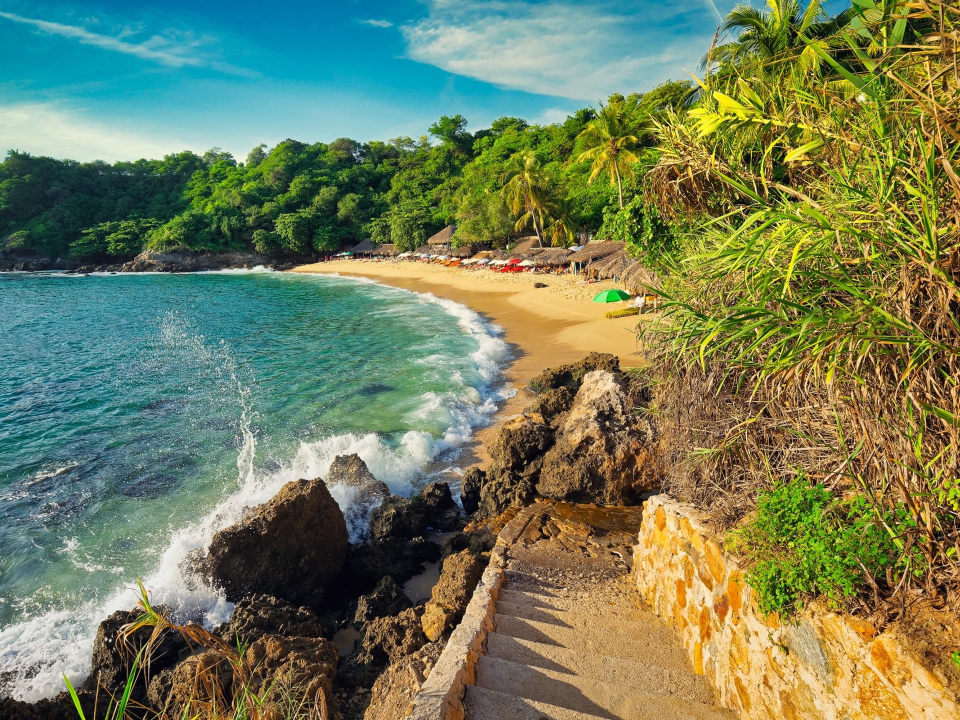 Beach in Puerto Escondido on a sunny day with some clouds