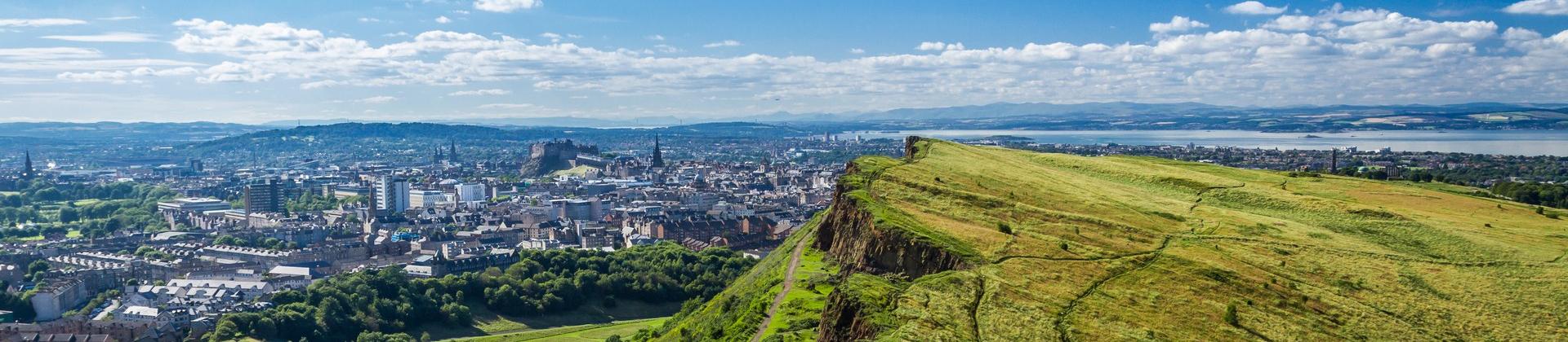 Aerial view of countryside in Edinburgh on a sunny day with some clouds