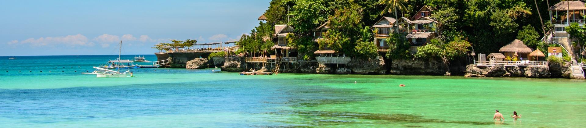 Beach with turquise water in Boracay on a sunny day with some clouds