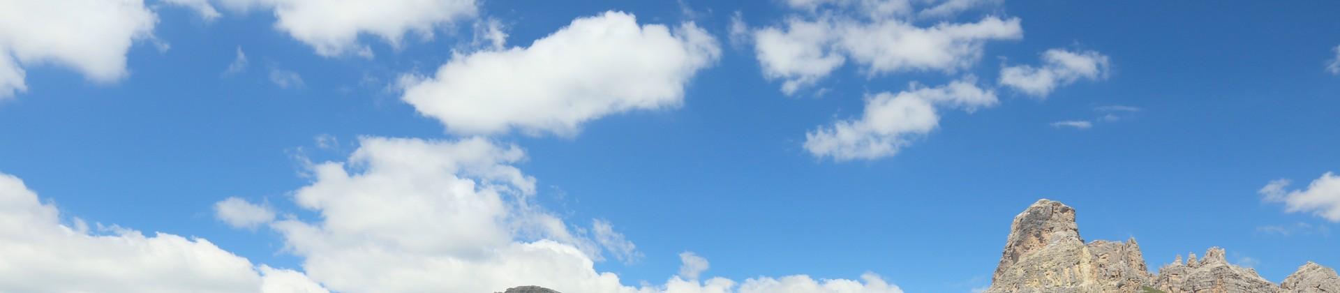 Aerial view of mountain range in Corvara in Badia in sunny weather with few clouds
