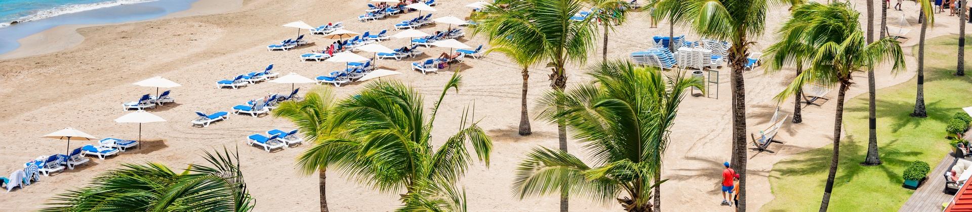 People on the beach in San Juan on a sunny day with some clouds