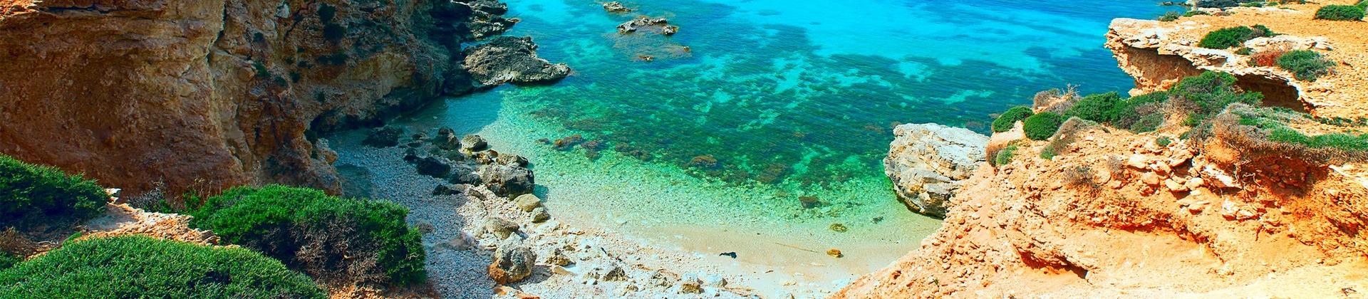 Beach with turquise water near Gozo with nice weather and blue sky