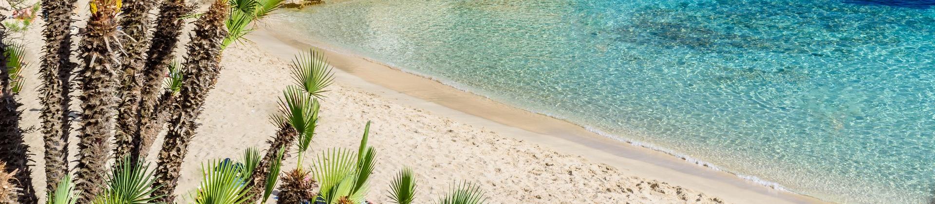 Amazing beach with turquise water in Cala Rajada in partly cloudy weather