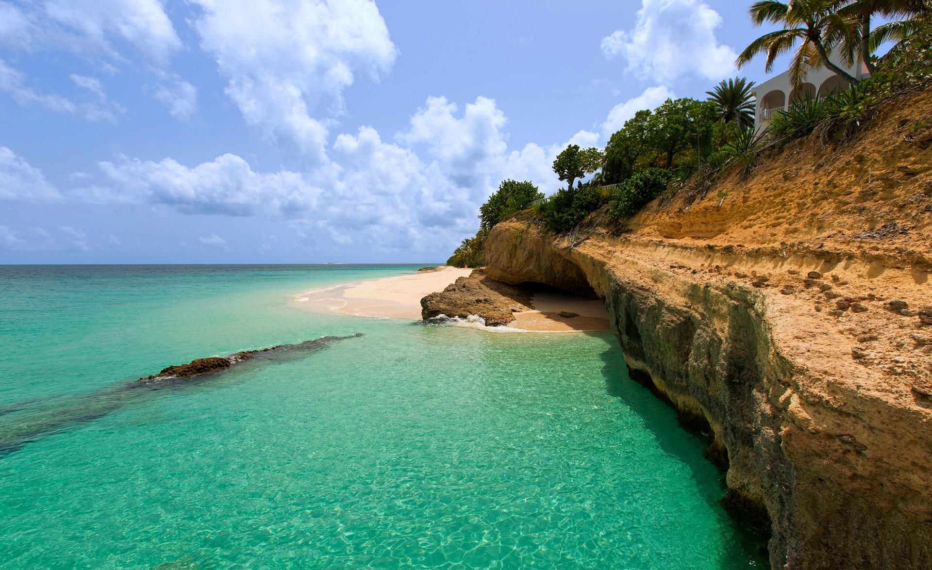 Beach with turquise water in Anguilla on a day with cloudy weather