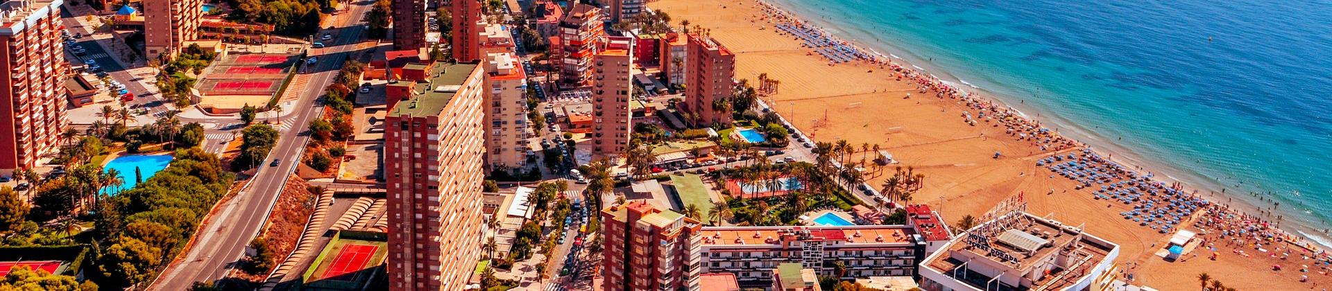 Aerial view of beach in Benidorm in sunny weather with few clouds