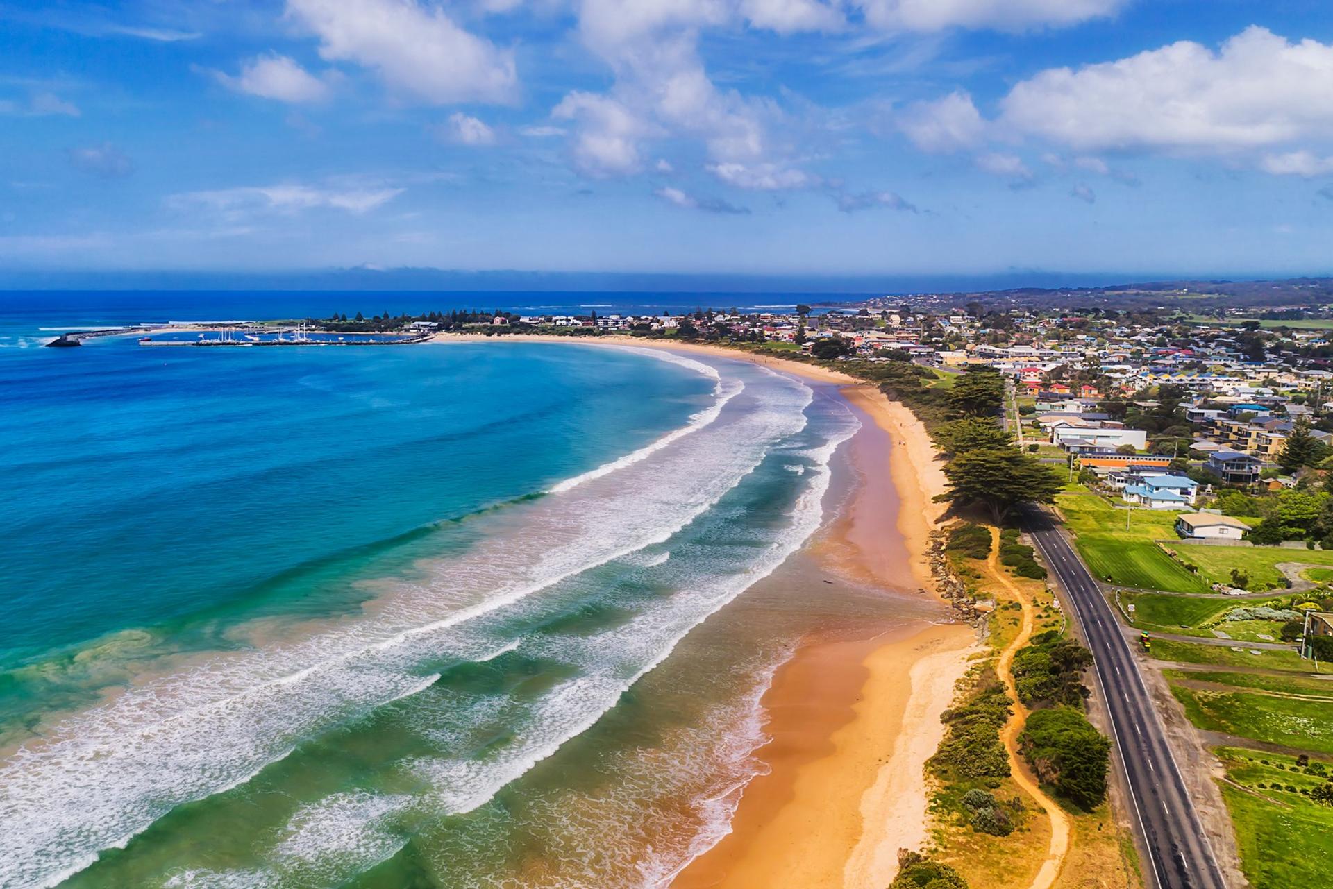 Aerial view of beach in Apollo Bay in sunny weather with few clouds